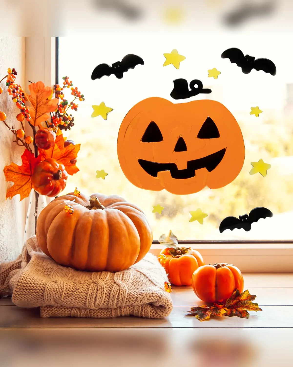 Jack-o'-lantern and bat gel window clings on a rental apartment window