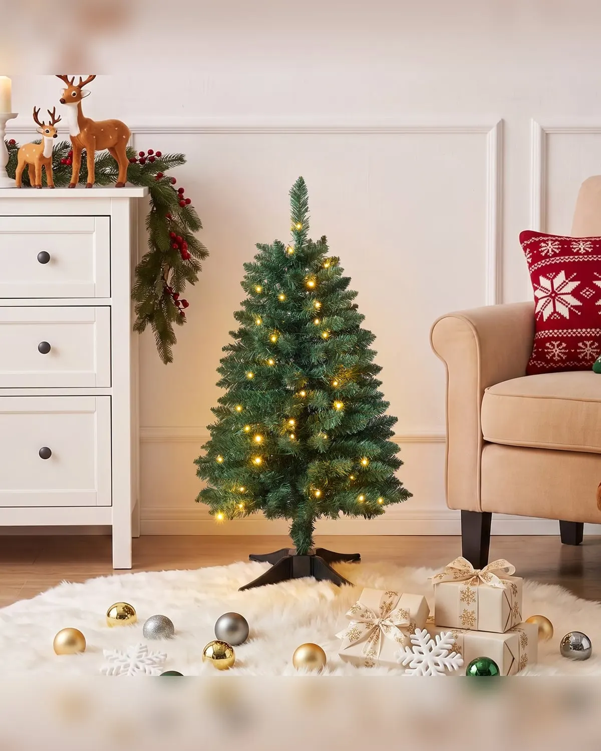 Small pre-lit tabletop Christmas tree with warm white lights in an apartment
