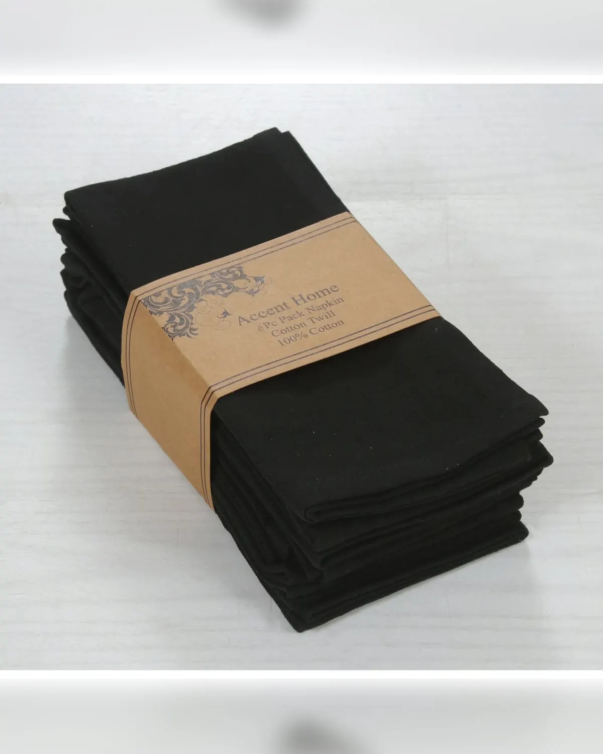 A stack of folded black cotton dinner napkins tied with a band