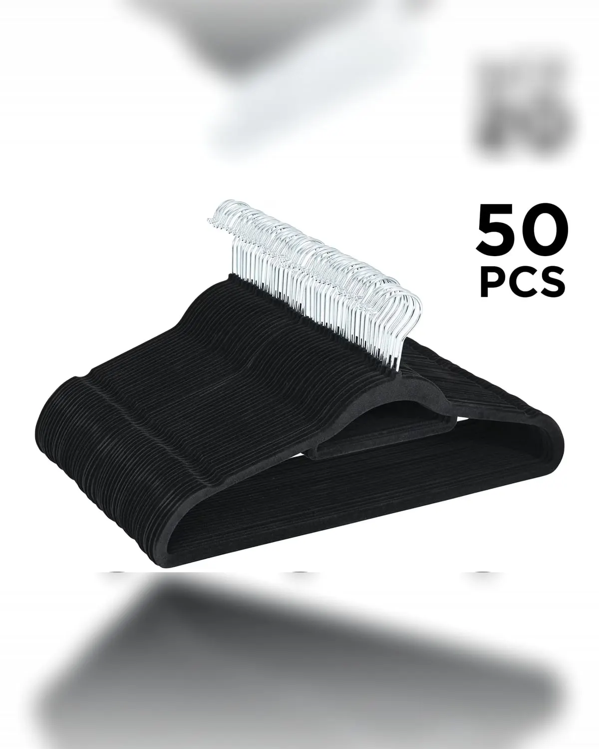 Fifty slim black velvet clothes hangers on a closet rod