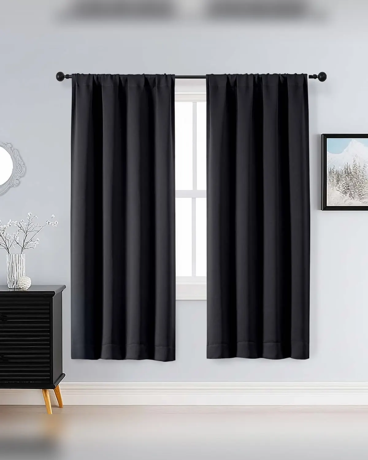 Black blackout curtain panels on a bedroom window
