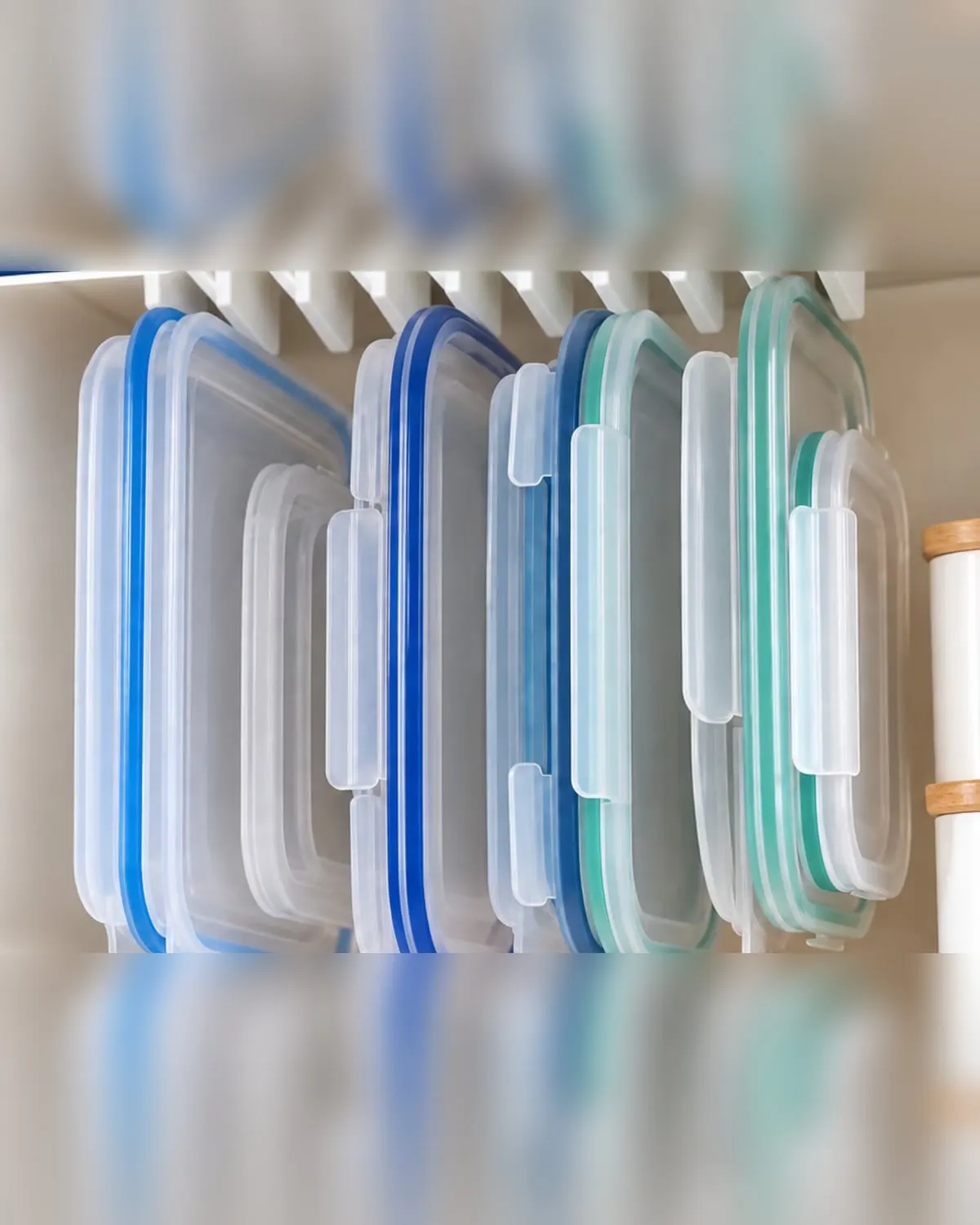 Plastic container lids filed upright in a hanging 10-slot organizer