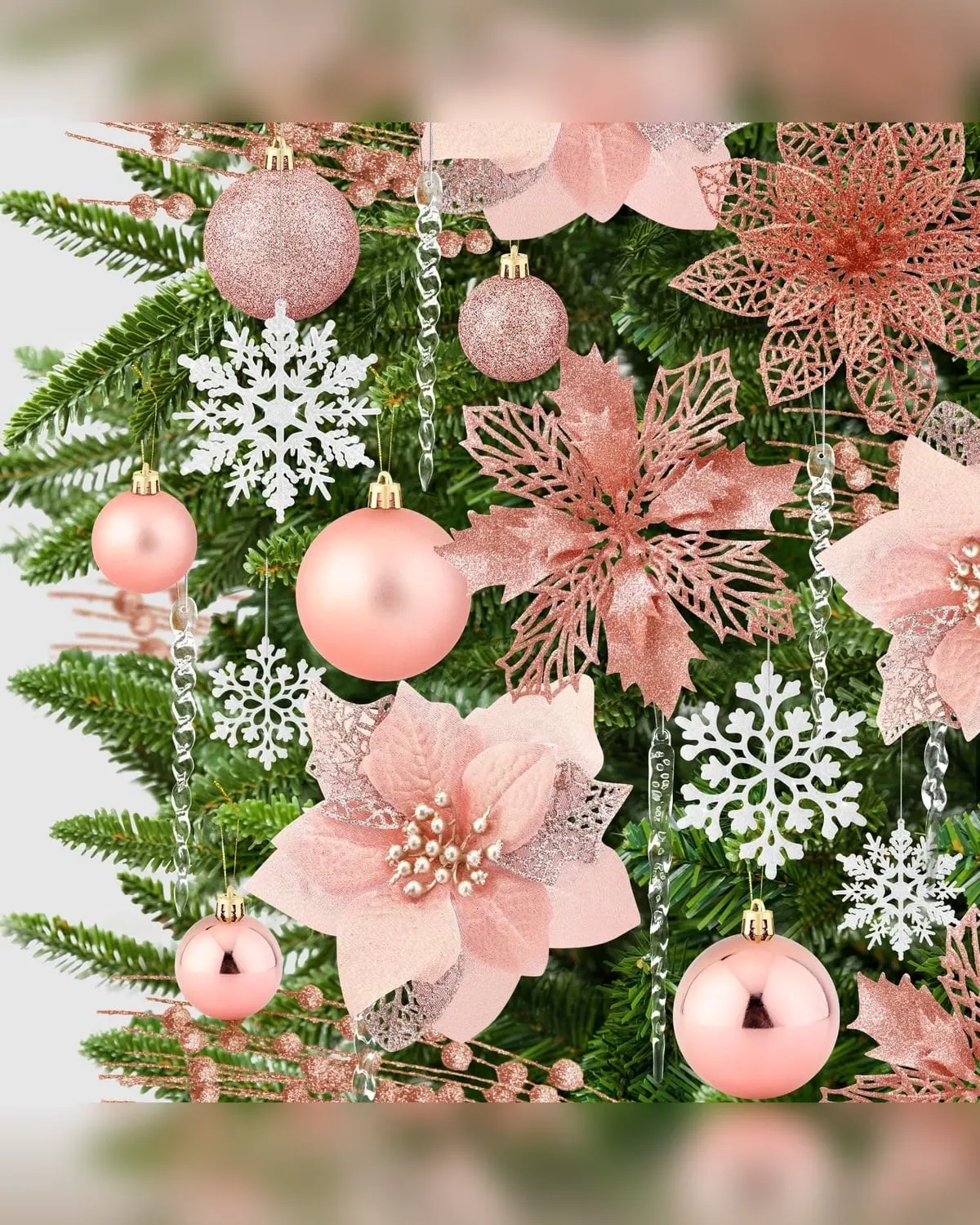 Rose-gold Christmas ornament set arranged on a small tree