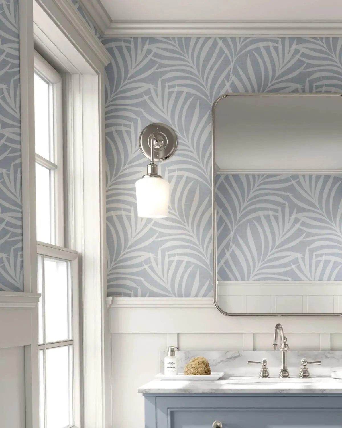 Light blue palm leaf peel-and-stick wallpaper on a small bathroom wall