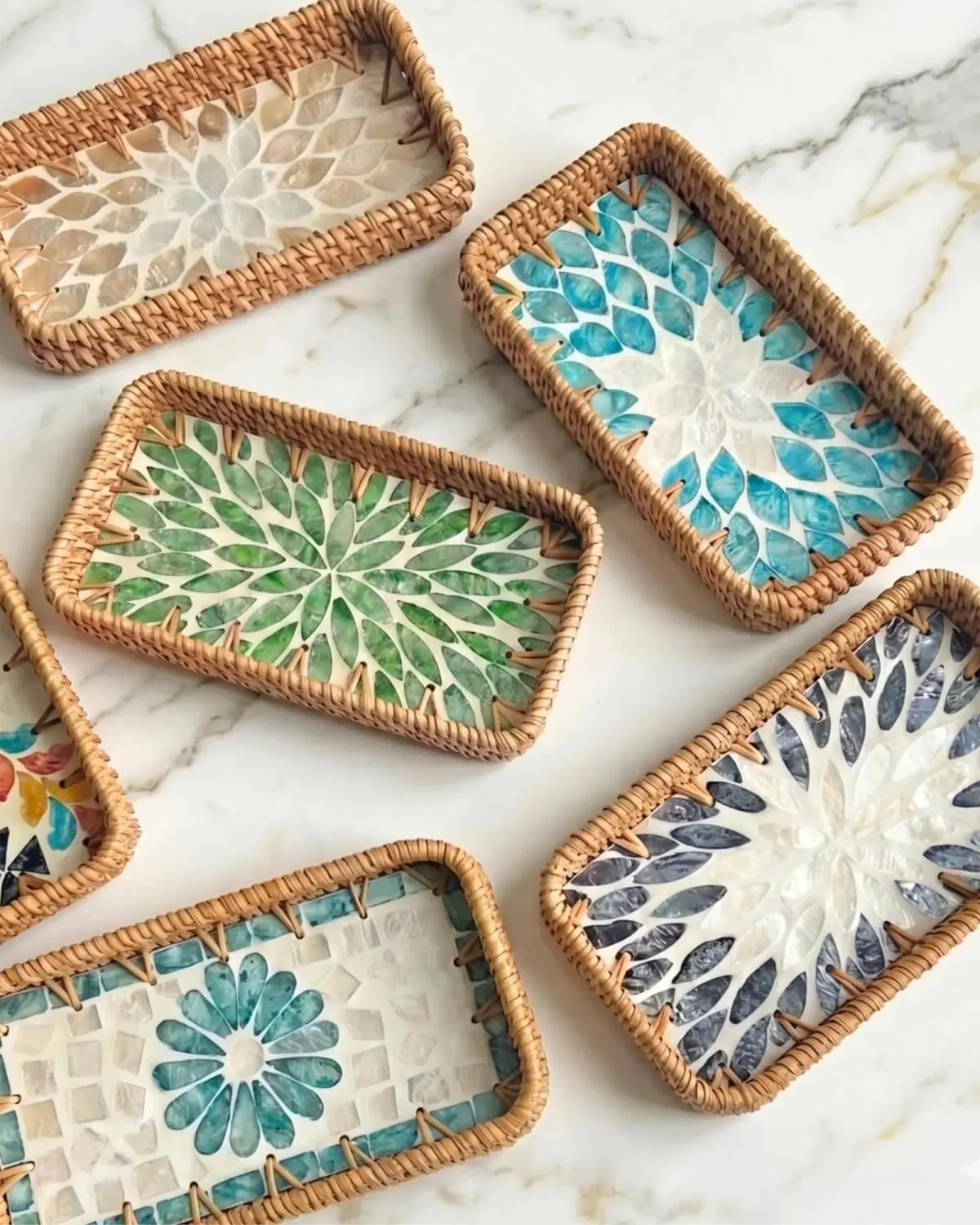 Four handmade rattan trays with floral mother-of-pearl inlay