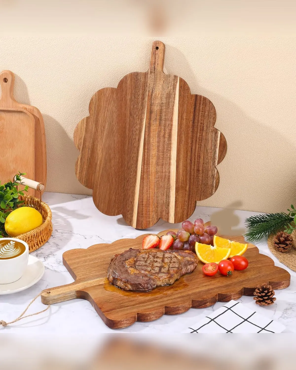 Two scalloped acacia wood serving boards with cheese and fruit