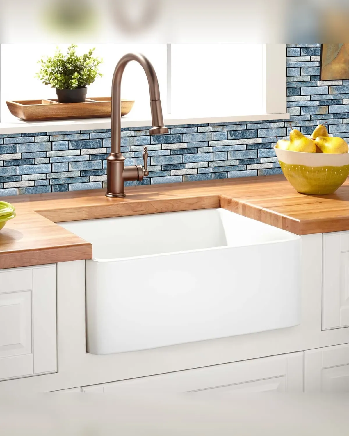 Peel-and-stick marble backsplash tiles behind a kitchen counter