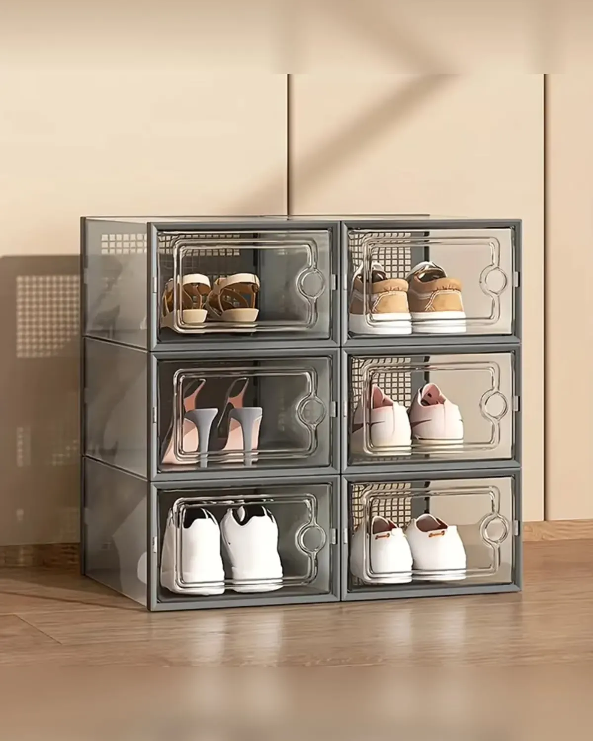 Stack of clear plastic shoe boxes with lids holding visible shoes