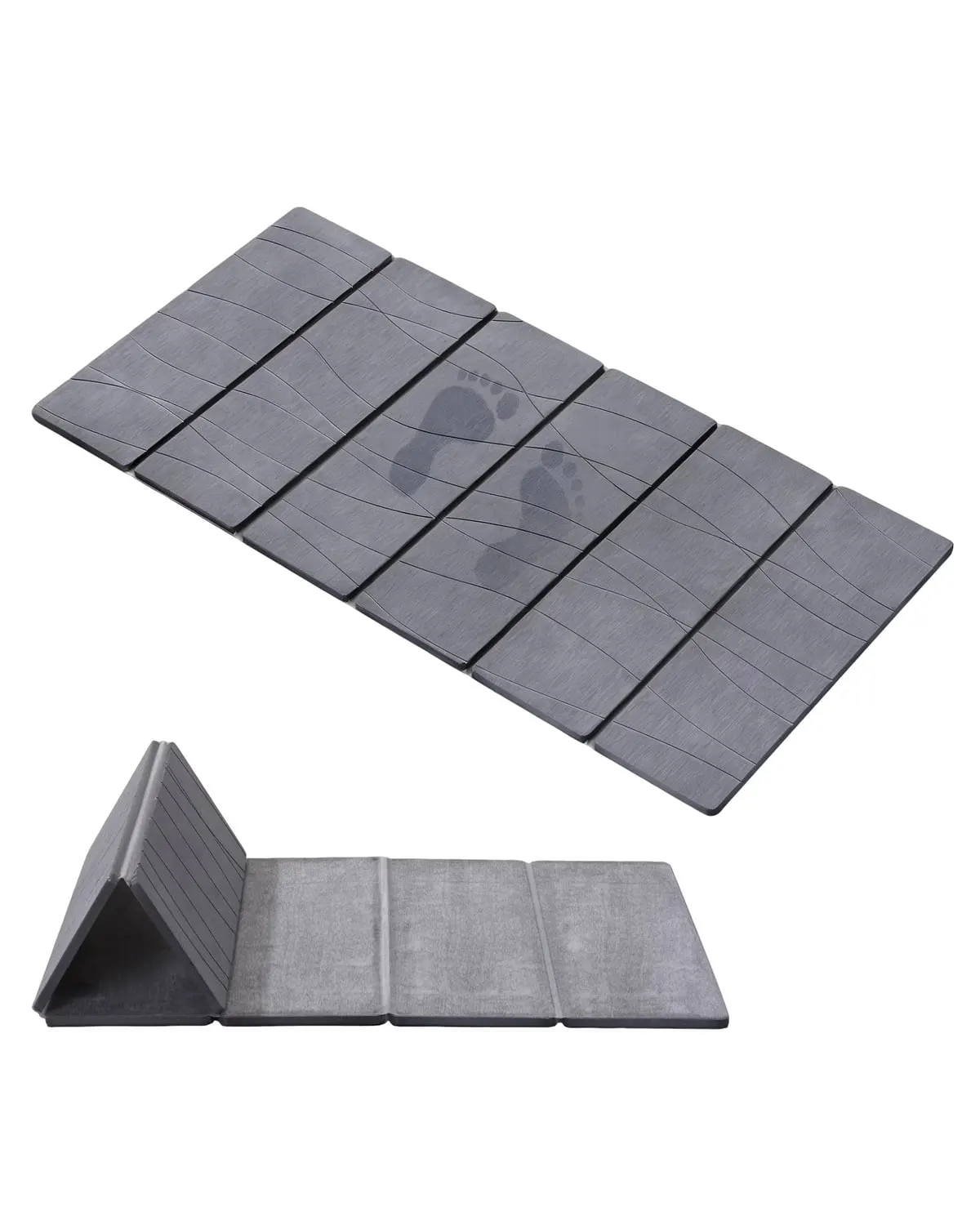Dark grey foldable stone bath mat on the floor of a small bathroom