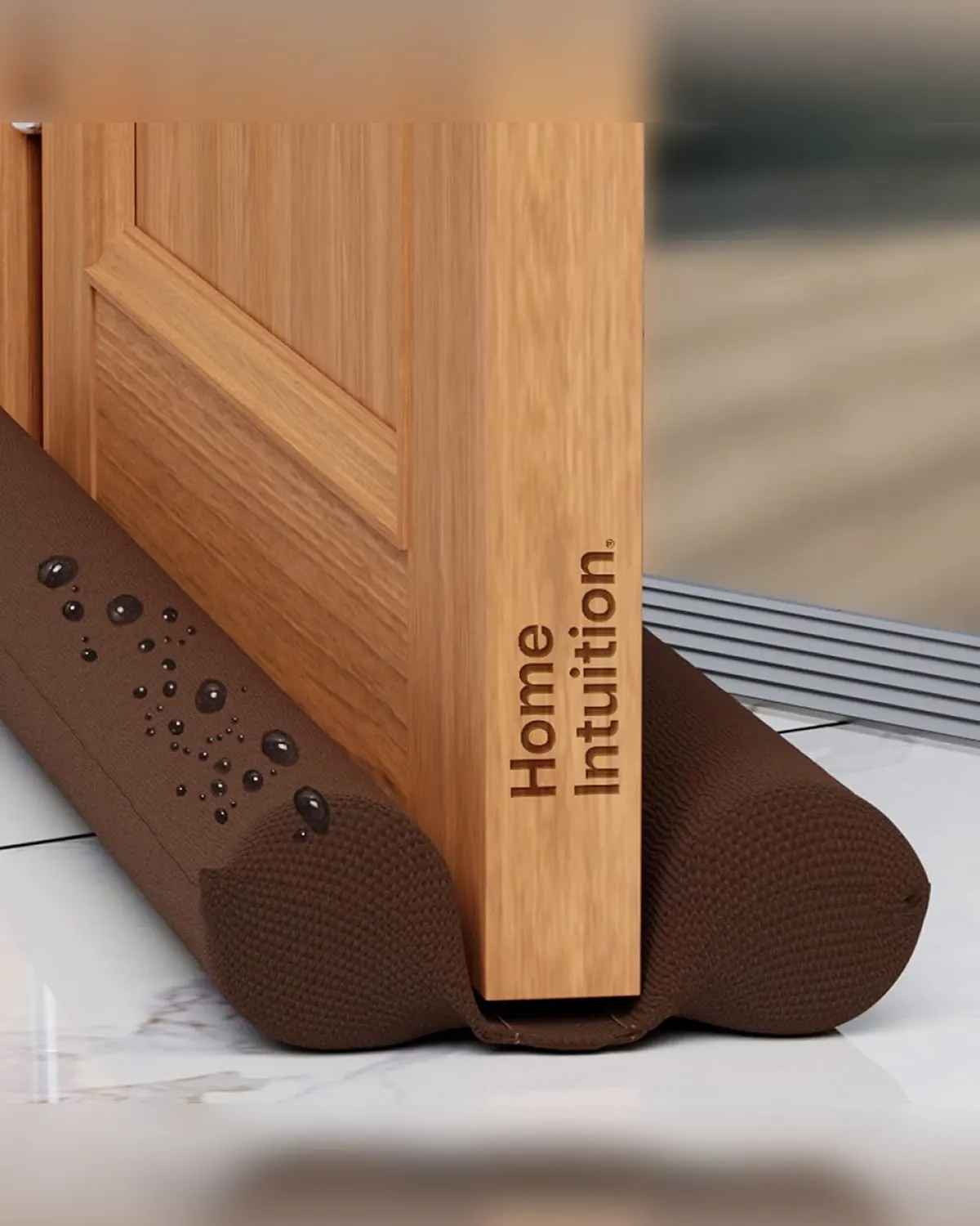 Brown under-door draft stopper sealing the bottom of a door