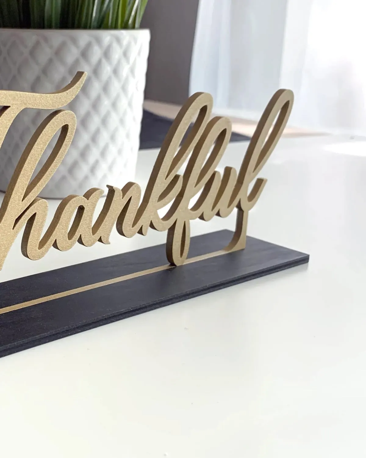 Freestanding wooden Thankful sign on a Thanksgiving table