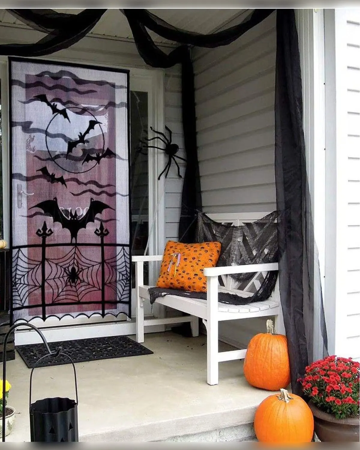 Black lace spider web and bat curtain panel hanging in an apartment doorway
