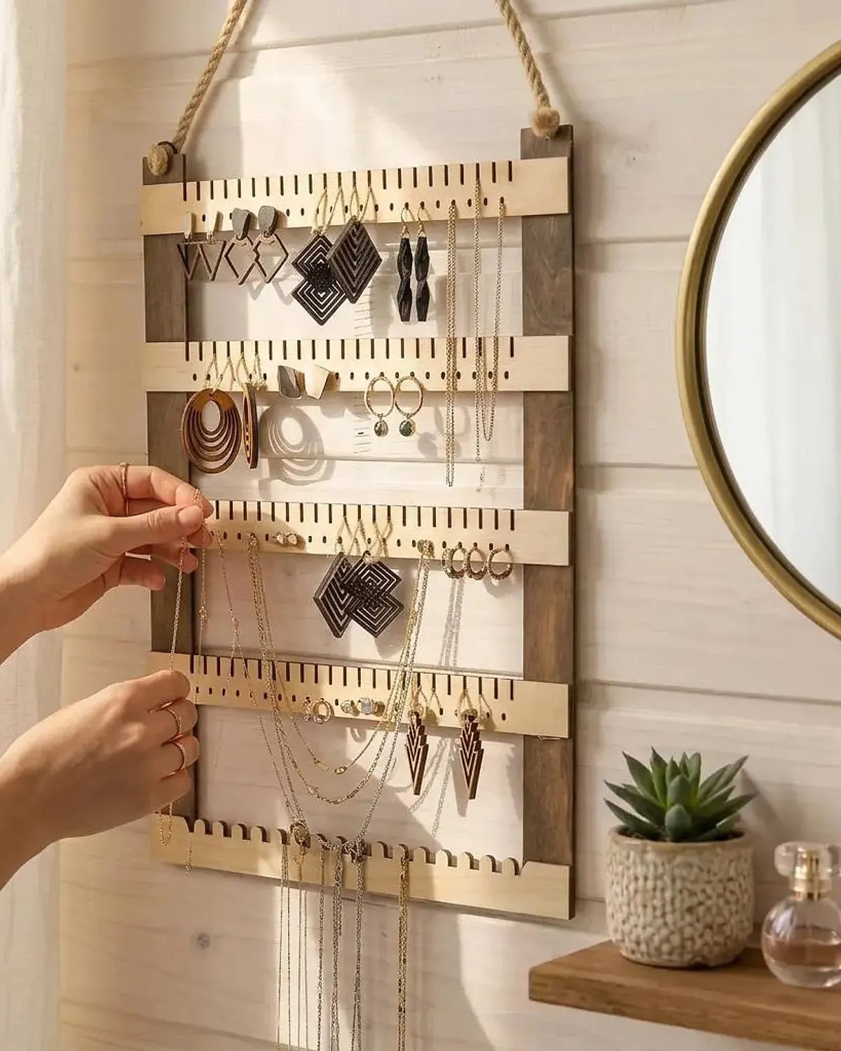 Handmade wall jewelry organizer displaying earrings and necklaces