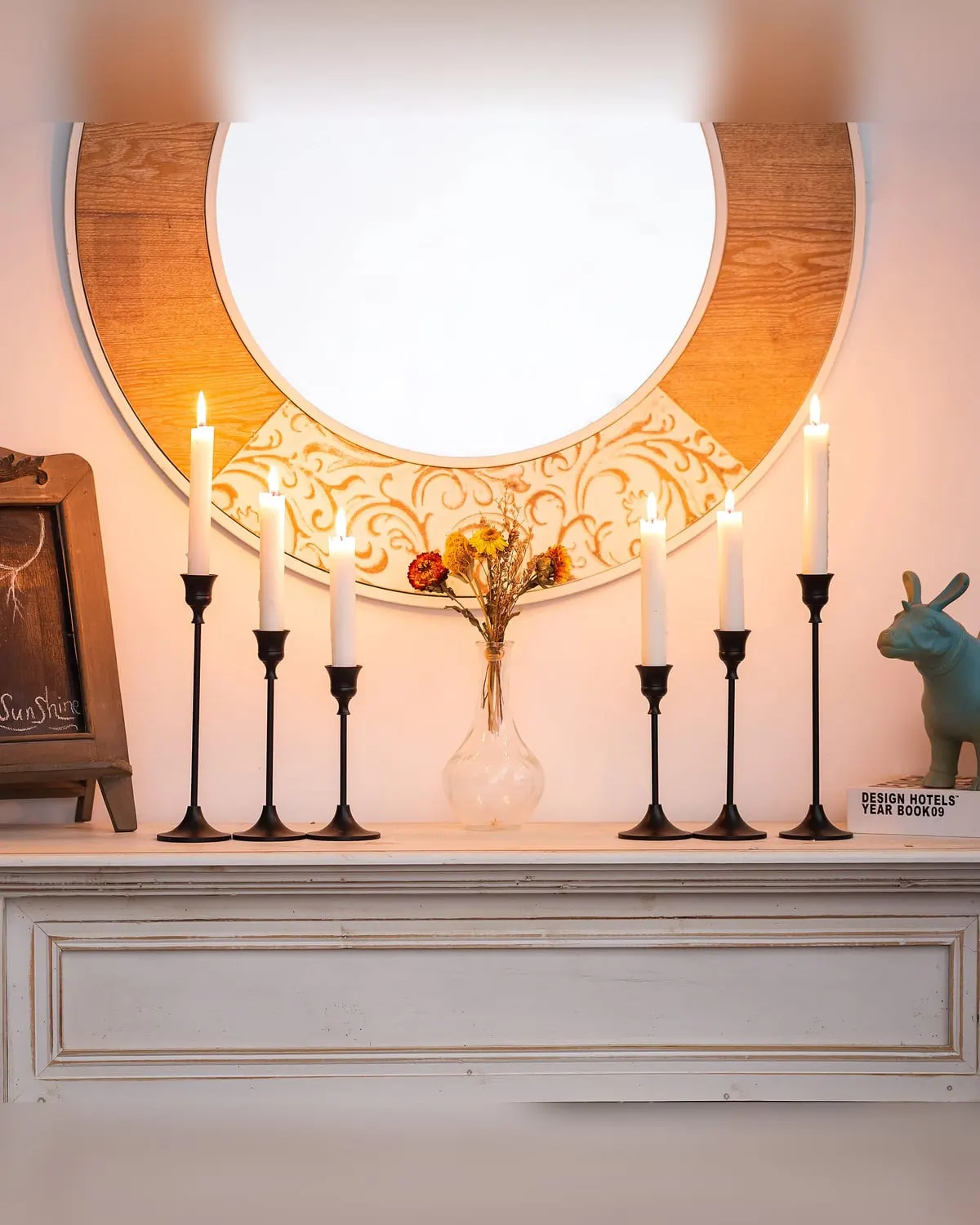Set of six slim black taper candle holders on an entry table