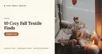 A cosy autumn windowsill — an open book, a cream knit throw, dried flowers in a mug, fallen leaves and lit candles against a rain-flecked window, with the headline '10 Cozy Fall Textile Finds'